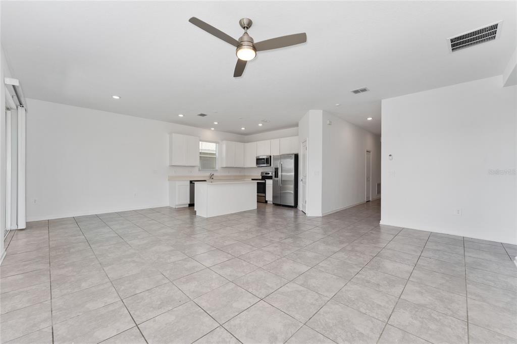 566 Hatteras Road Davenport, FL 33837 - Photo 5 of 28 a view of a kitchen with a sink and a refrigerator