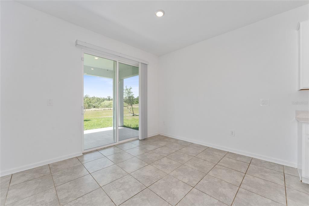 566 Hatteras Road Davenport, FL 33837 - Photo 7 of 28 an empty room with windows