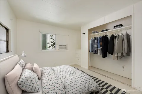 a bedroom with a bed and a walk in closet