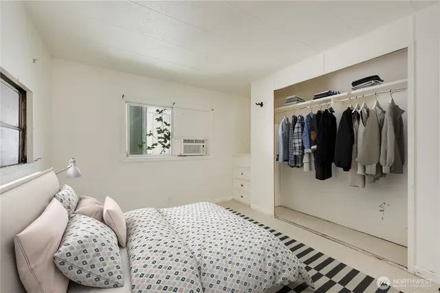 a bedroom with a bed and a walk in closet