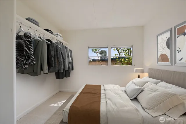 a bedroom with a bed and a window