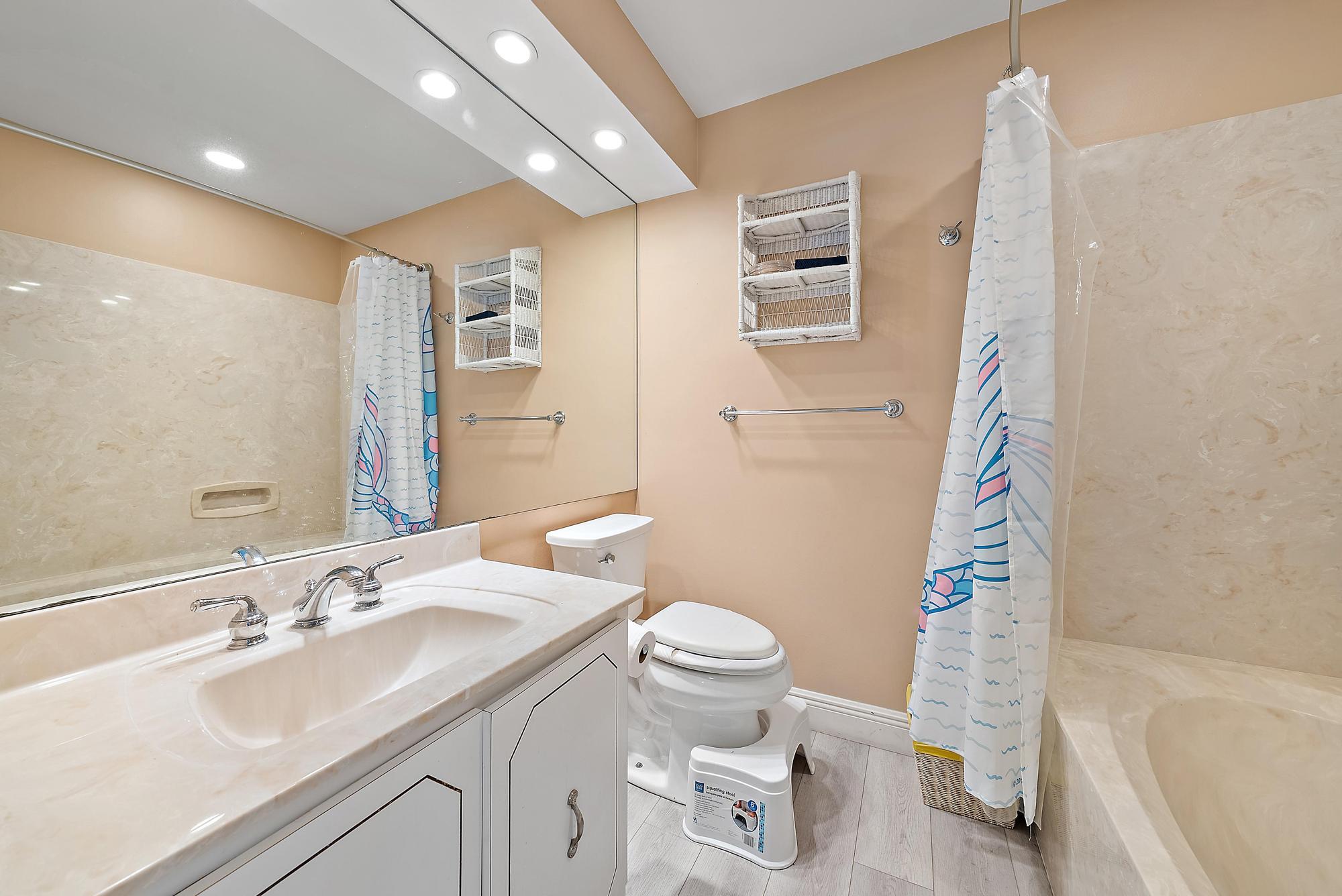 16338 Alexander Run Jupiter, FL 33478 - Photo 18 of 32 a bathroom with a sink toilet and shower