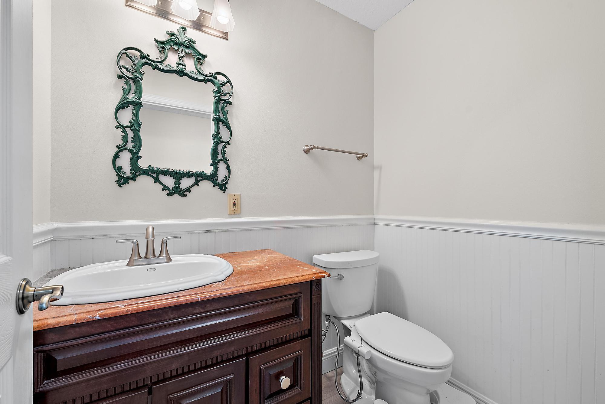 16338 Alexander Run Jupiter, FL 33478 - Photo 22 of 32 a bathroom with a sink toilet and mirror