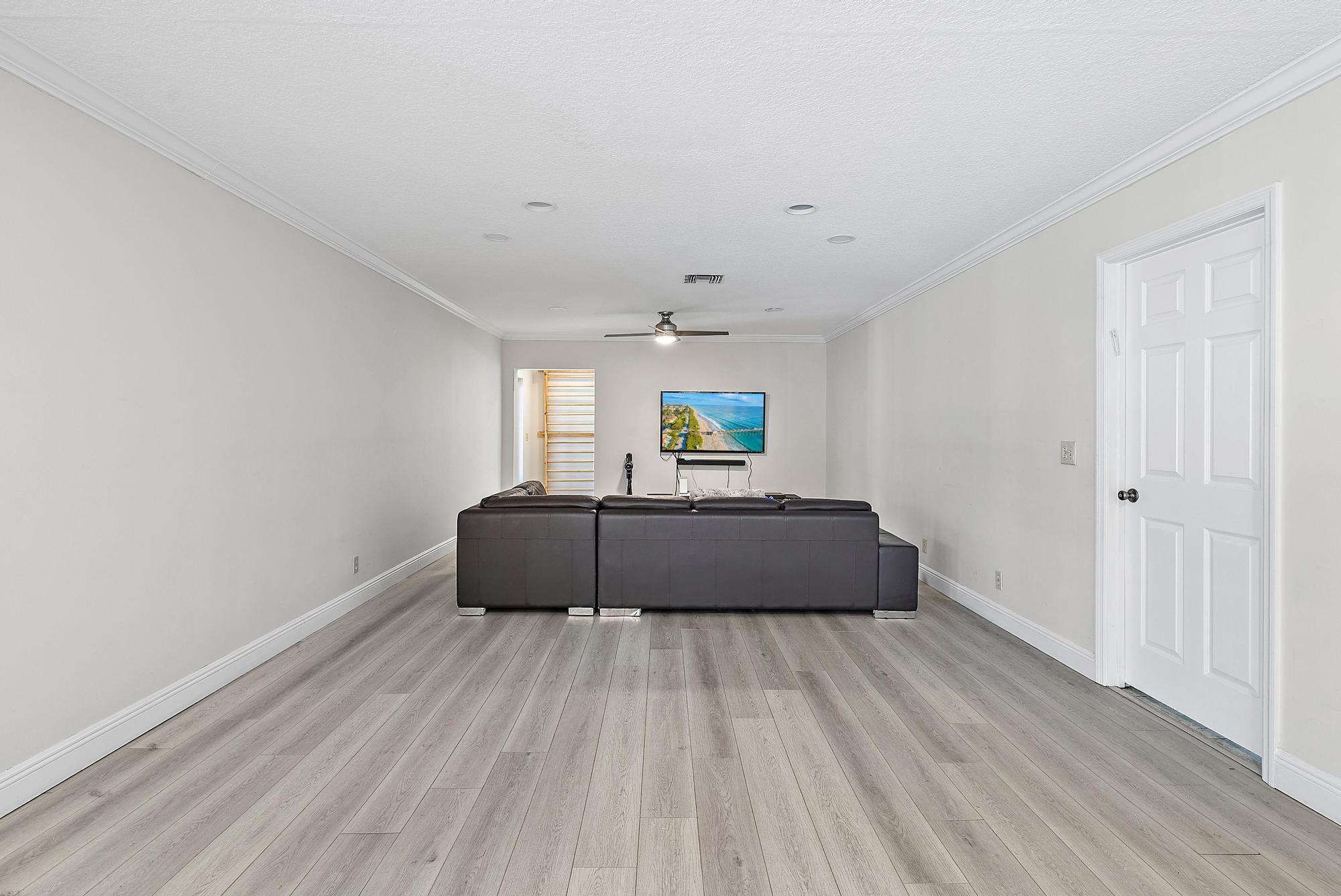 16338 Alexander Run Jupiter, FL 33478 - Photo 5 of 32 a living room with a bed and a window
