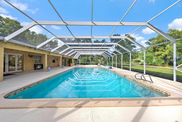 a view of a backyard with a swimming pool