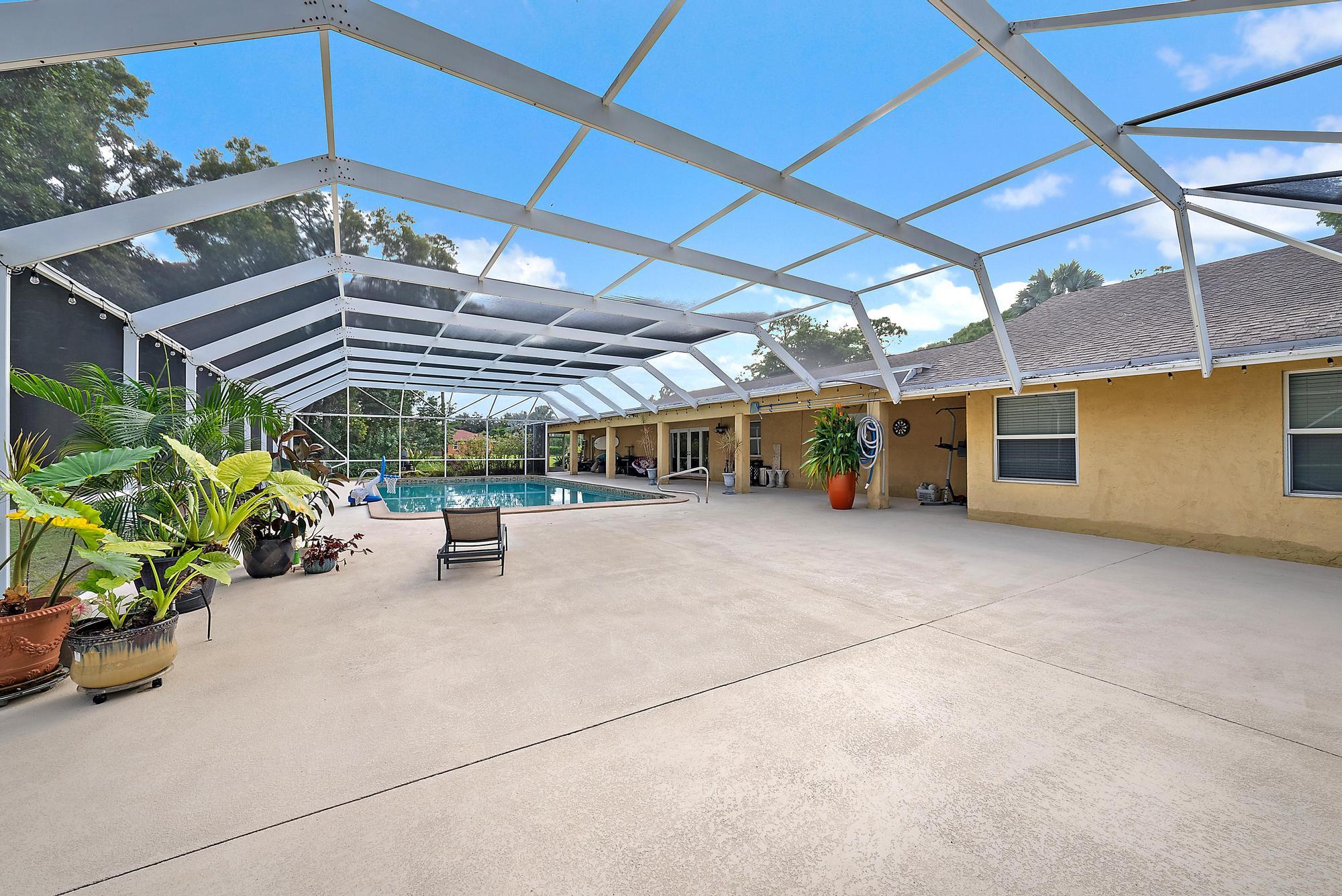 16338 Alexander Run Jupiter, FL 33478 - Photo 8 of 32 a view of a chairs and table in the patio