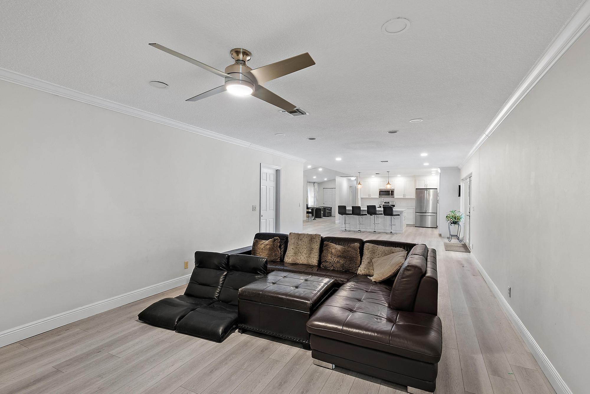 16338 Alexander Run Jupiter, FL 33478 - Photo 9 of 32 a living room with furniture and a wooden floor