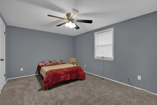 a bathroom with a granite countertop toilet sink and mirror