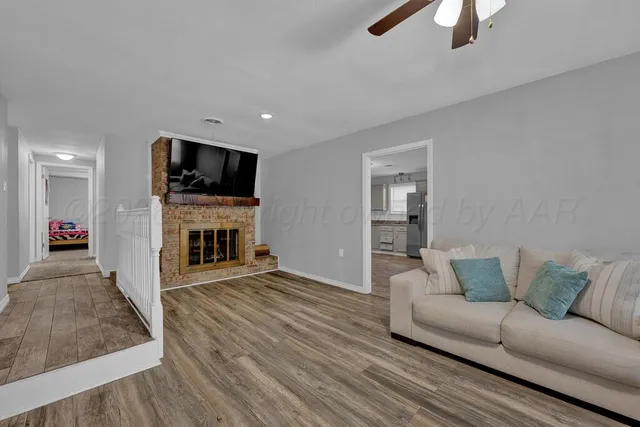 a living room with furniture a fireplace and a flat screen tv