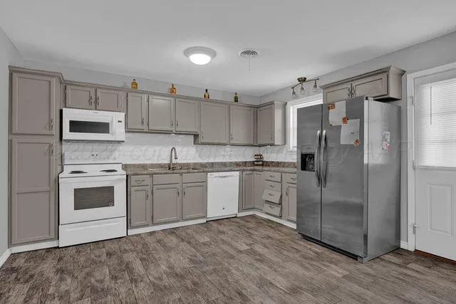 a kitchen with stainless steel appliances a refrigerator and microwave