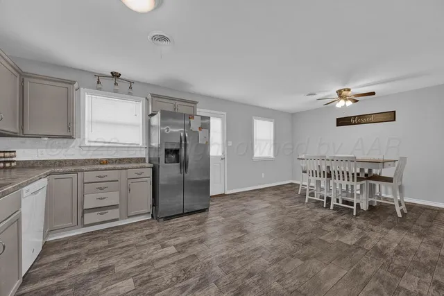 a view of a livingroom with furniture and chandelier fan