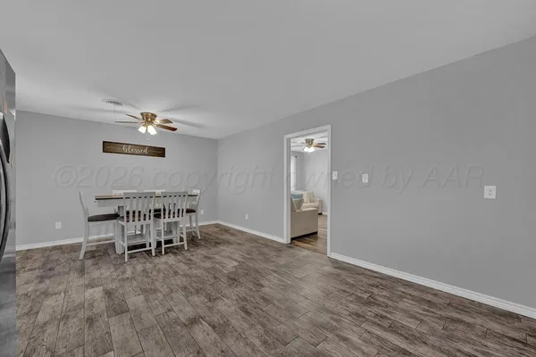 a view of a dining room with furniture and a window