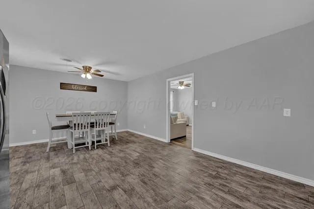a view of a dining room with furniture and a window