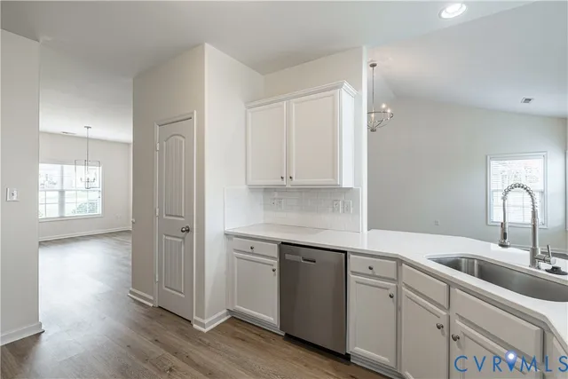 a kitchen with a sink cabinets and wooden floor