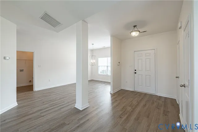 a view of an empty room and wooden floor