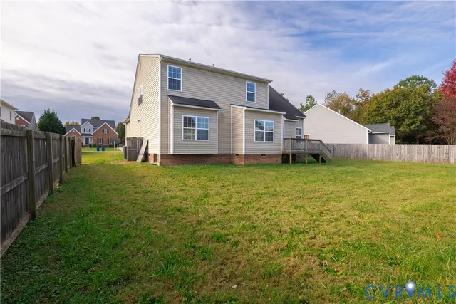a view of yard with green space and wooden fence