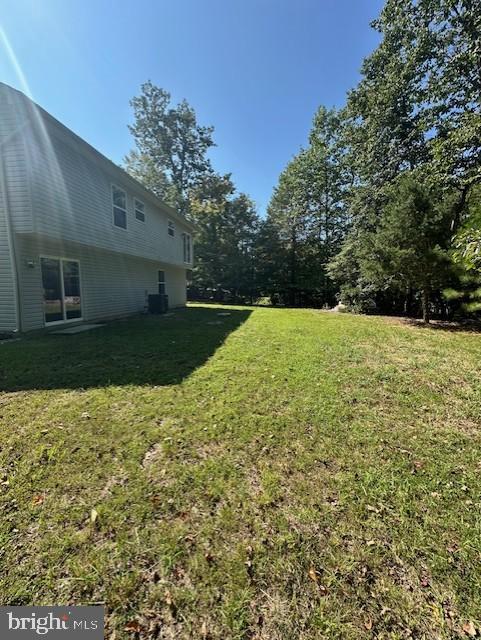 12627 Hilltop Road Lusby, MD 20657 - Photo 3 of 4 Spacious backyard bathed in sunlight.