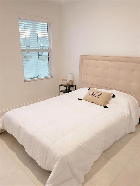 136 Honeysuckle Street Princeton, TX 75407 - Photo 11 of 13 a large white bed in a white room