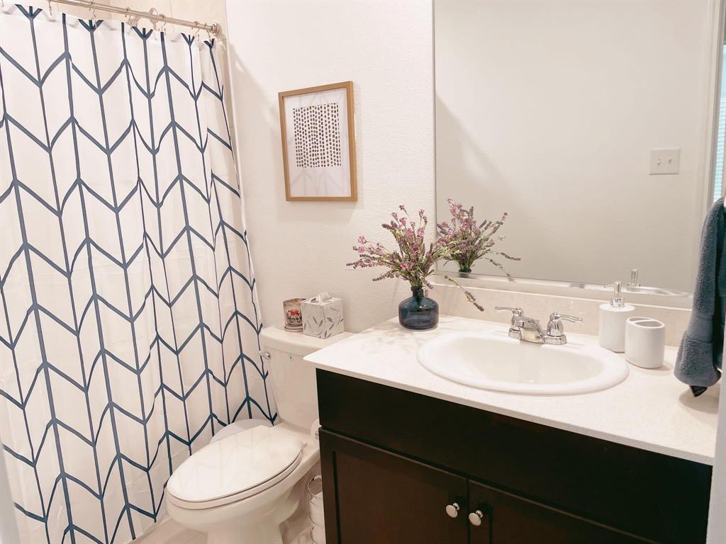 136 Honeysuckle Street Princeton, TX 75407 - Photo 13 of 13 a bathroom with a sink toilet and mirror