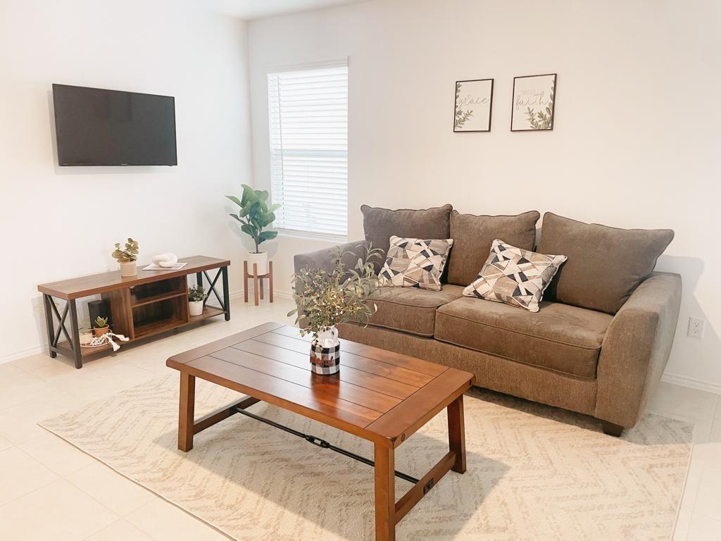 136 Honeysuckle Street Princeton, TX 75407 - Photo 3 of 13 a living room with furniture and a flat screen tv