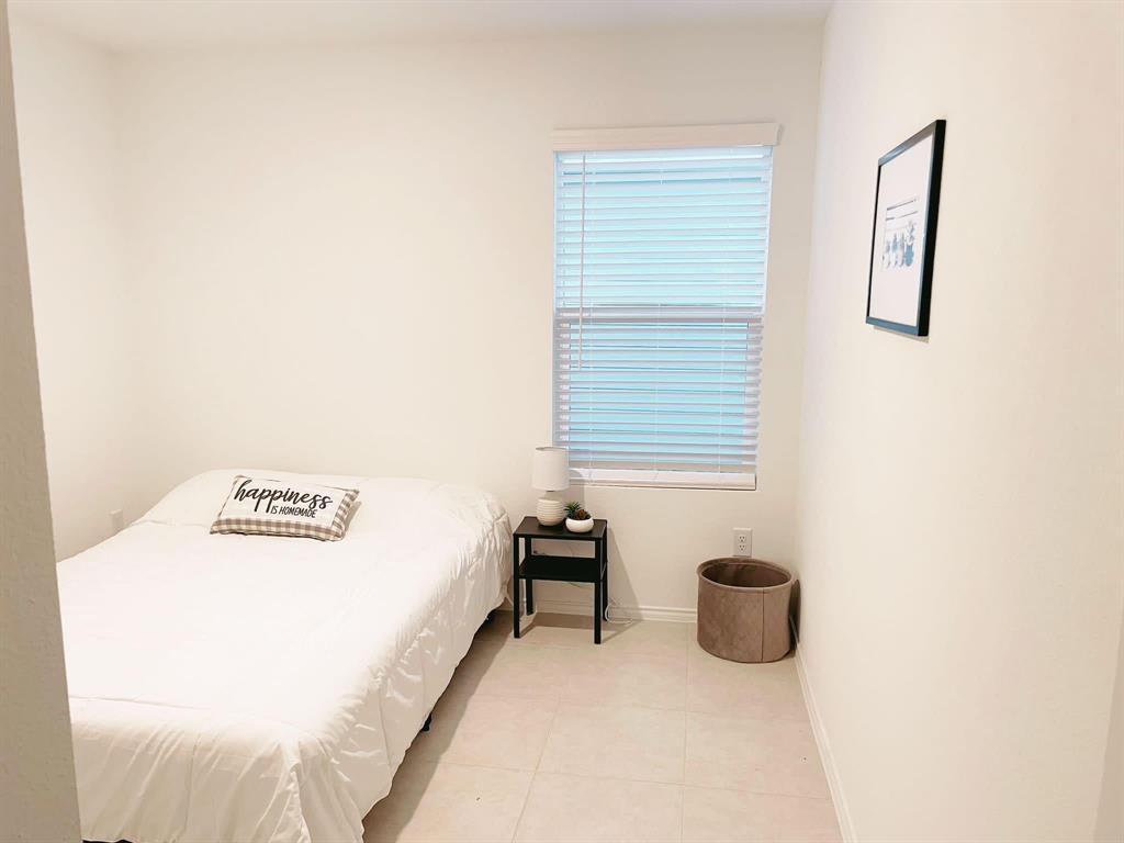 136 Honeysuckle Street Princeton, TX 75407 - Photo 10 of 13 a view of a bedroom with a bed