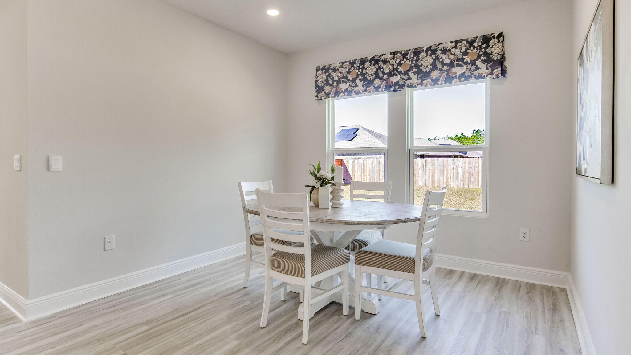 8688 Bluebell Street Milton, FL 32583 - Photo 12 of 32 a view of a dining room with furniture window and wooden floor