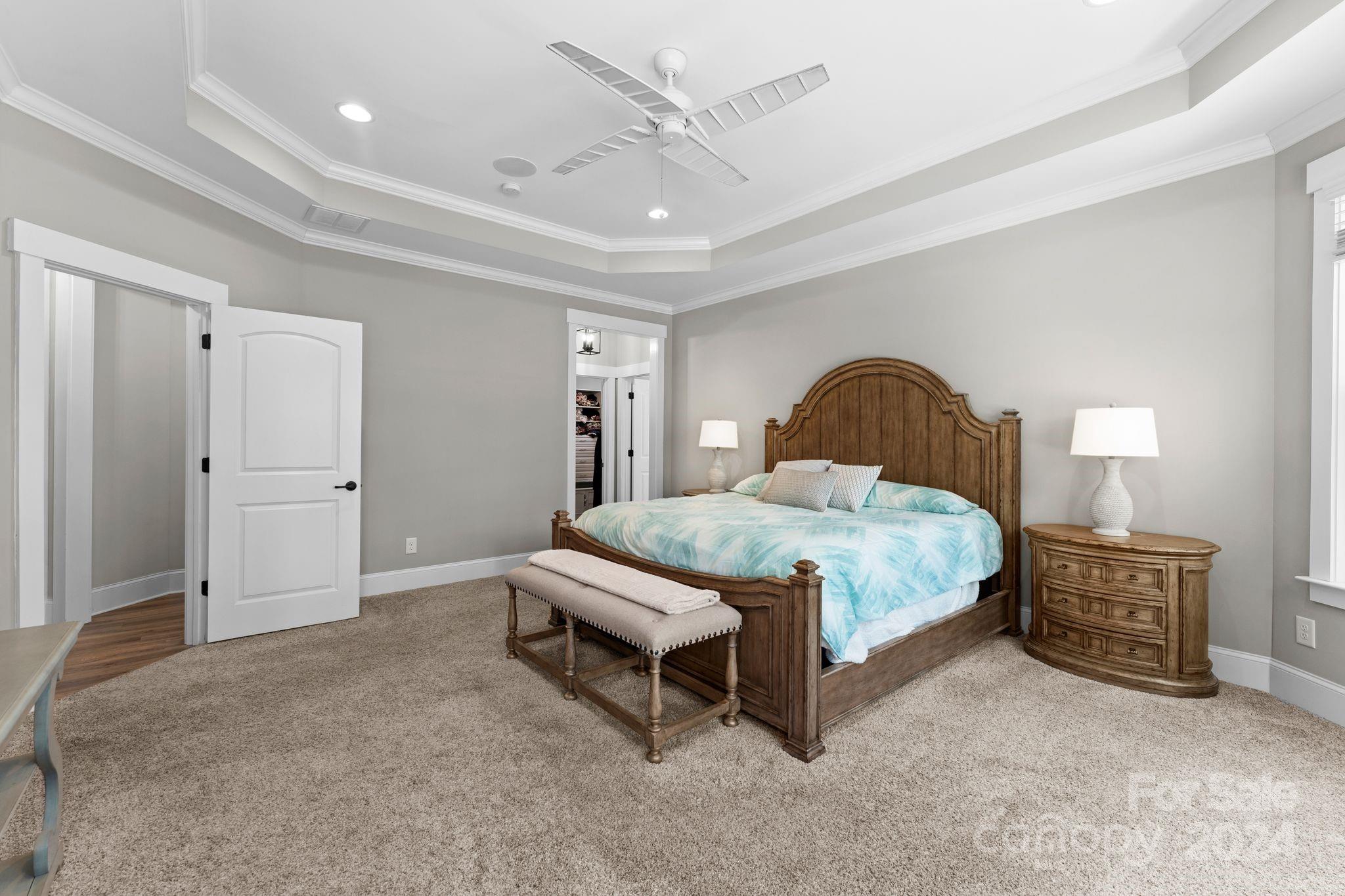 6084 Chimney Bluff Road Lancaster, SC 29720 - Photo 23 of 39 a spacious bedroom with a bed and a chandelier