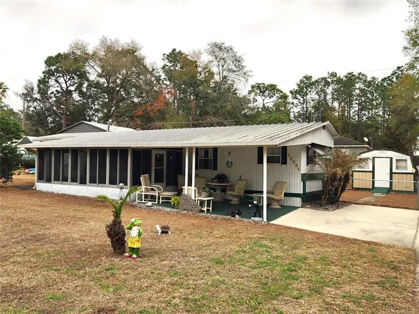 a view of a house with yard and sitting area