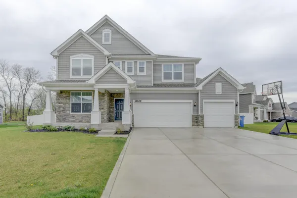a front view of a house with a yard and garage