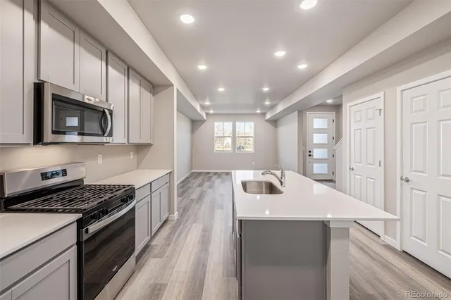 a kitchen that has a sink and a stove in it
