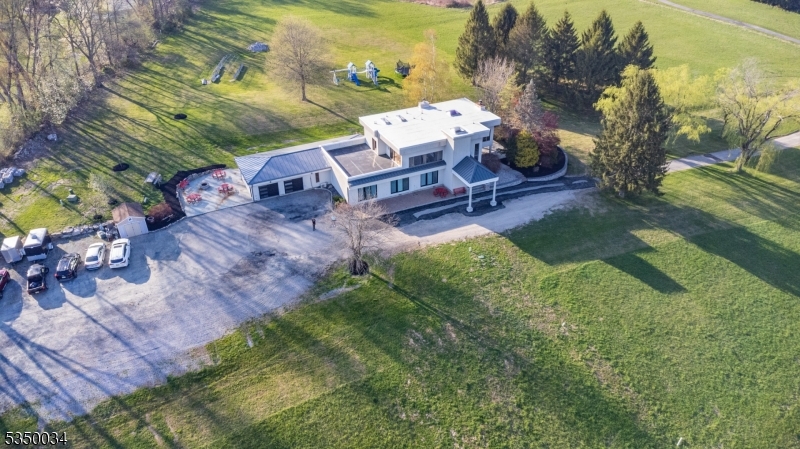 an aerial view of a house with garden space and street view