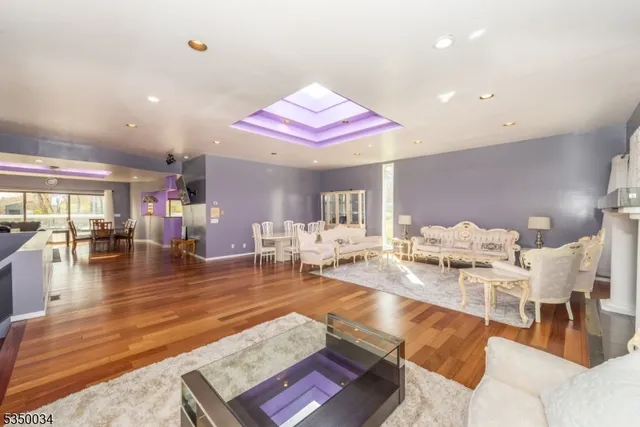 a living room with furniture kitchen view and a large window