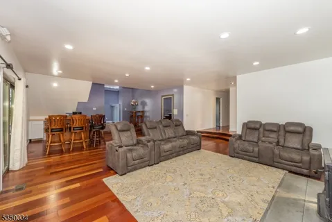 a spacious bedroom with a bed and a flat screen tv