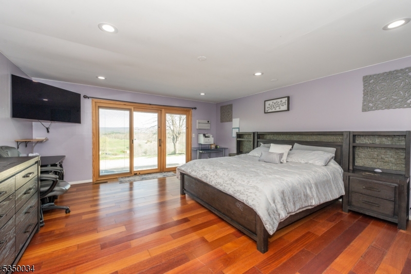 155 Route560 Layton, NJ 07851 - Photo 24 of 42 a spacious bedroom with a bed and a flat screen tv