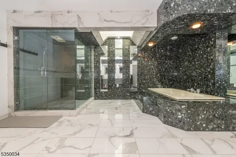 a living room with furniture and two windows