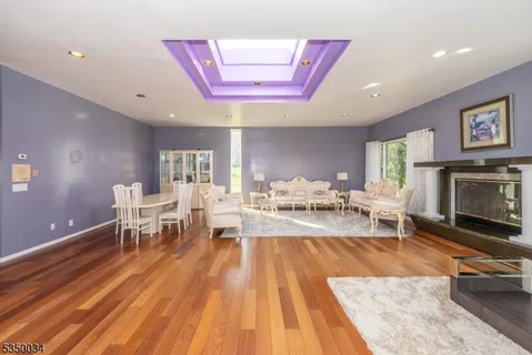 a living room with furniture a dining table and a fireplace