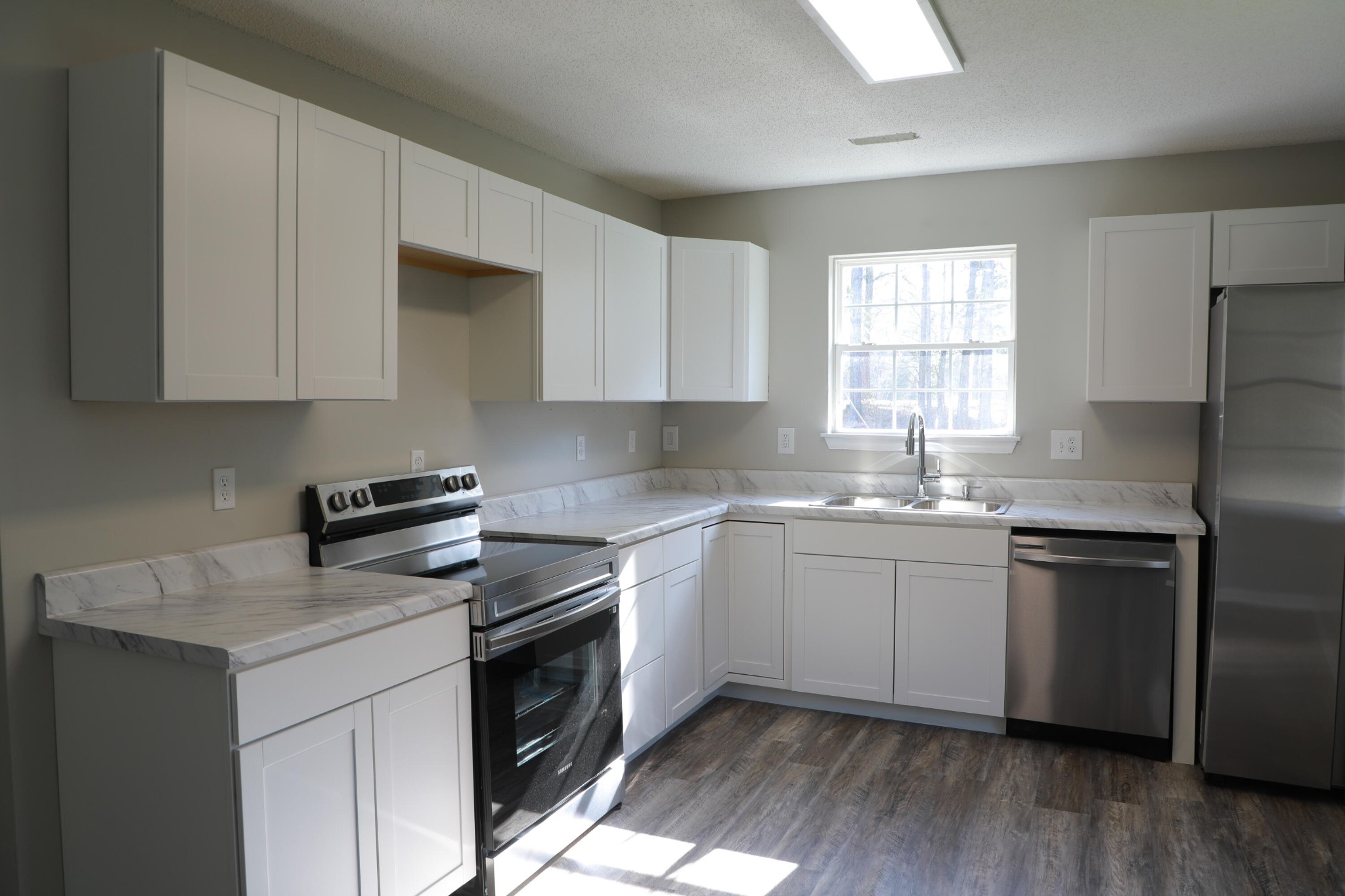 440 Samples Chapel Road Southeast Cleveland, TN 37323 - Photo 27 of 31 a kitchen with a sink stove and cabinets