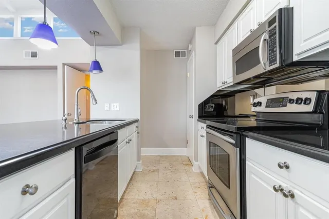 a kitchen with stainless steel appliances granite countertop a stove and a sink