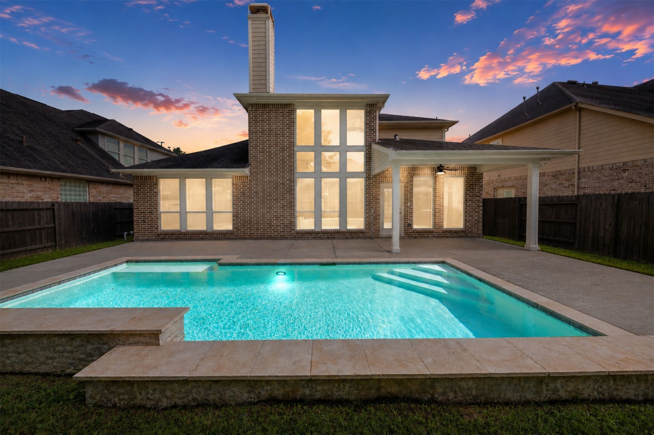 26422 Red Cliff Ridge Katy, TX 77494 - Photo 30 of 40 Lovely, early evening view of the pool and windowed rear of the home.