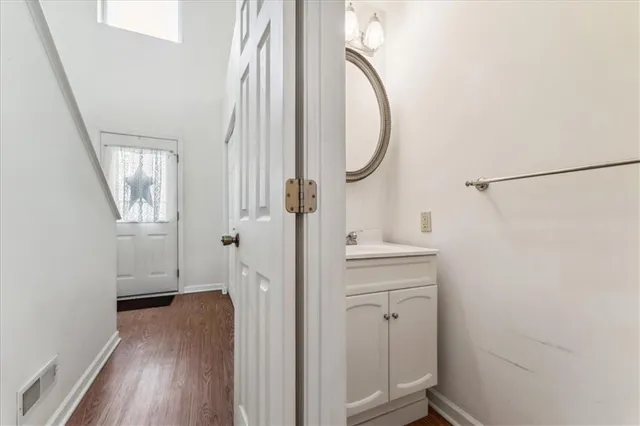 a view of a hallway with wooden floor and entryway