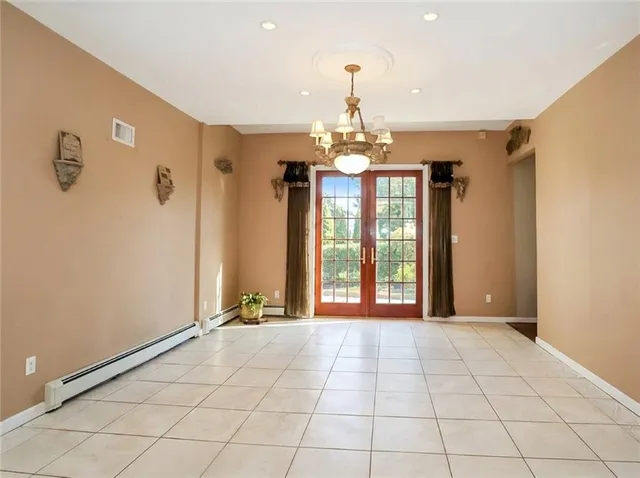 a view of an empty room with a chandelier