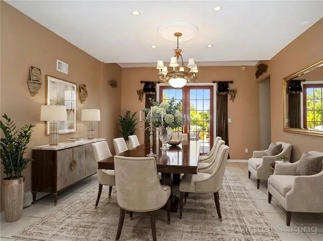 a view of a dining room with furniture and chandelier