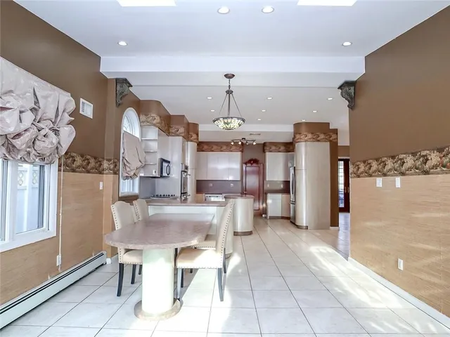 a kitchen with stainless steel appliances kitchen island granite countertop a refrigerator and microwave