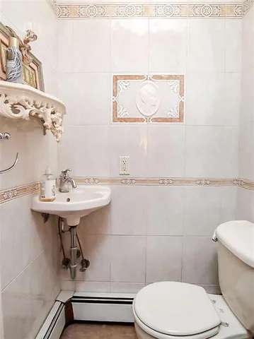a bathroom with a sink mirror and toilet