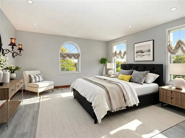 a spacious bedroom with a bed and a painting on the wall