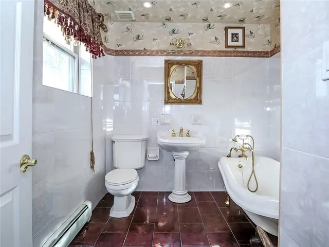 a bathroom with a toilet a sink and a shower