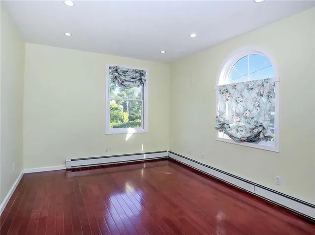 a view of a room with wooden floor and window