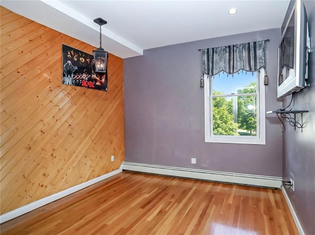 39 Hasbrouk Road Staten Island, NY 10304 - Photo 27 of 50 a view of an empty room with a window and wooden floor