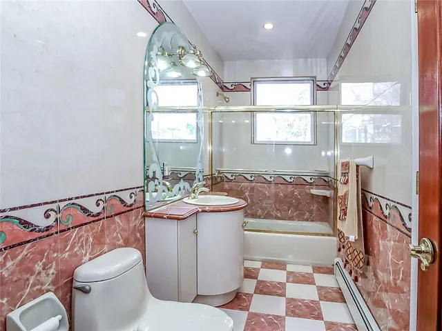 a bathroom with a sink mirror vanity and toilet