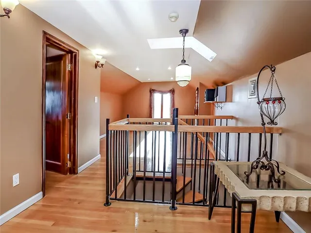 a view of entryway and hall with wooden floor